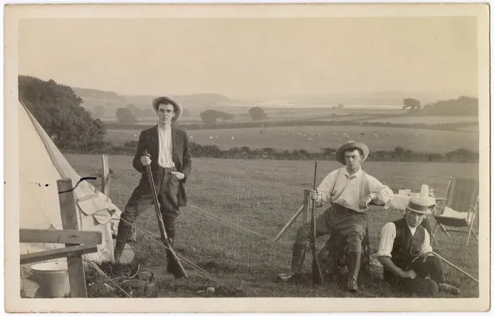 Framed Print : Three young men in a field beside a tent, two of them with rifles Date: circa 1910s Framed Print : Three young men in a field beside a tent, two of them with rifles Date: circa 1910s