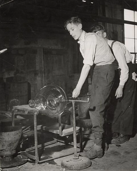 Young men spinning molten glass into a large cut glass bowl at Walsh Ltd