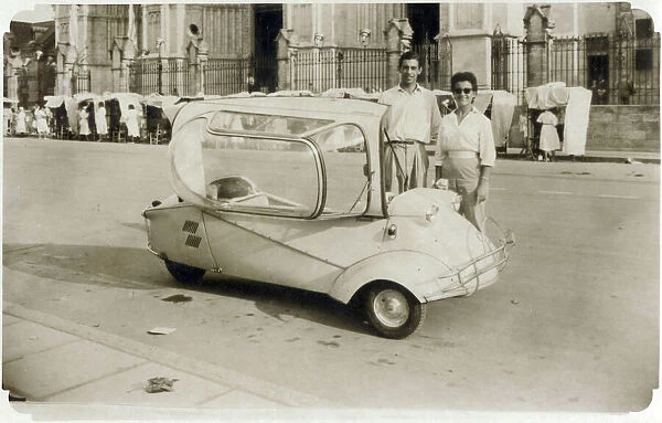 A young (possibly) Italian couple standing proudly next to their Messerschmitt KR200