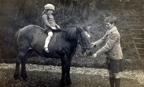 A young Scottish girl taken out for a ride on a pony