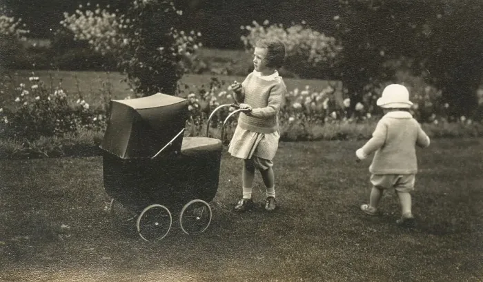 Framed Print : Two young siblings playing with a beautiful toy pram Framed Print : Two young siblings playing with a beautiful toy pram