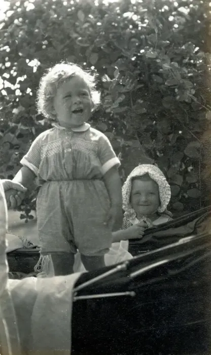 Framed Print : Two young siblings, one standing in a fine baby carriage Framed Print : Two young siblings, one standing in a fine baby carriage