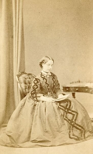 Young Victorian woman reading a letter