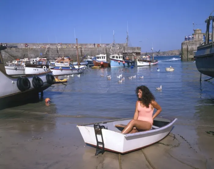 Framed Print : Young woman in a boat at Newquay harbour, Cornwall Framed Print : Young woman in a boat at Newquay harbour, Cornwall