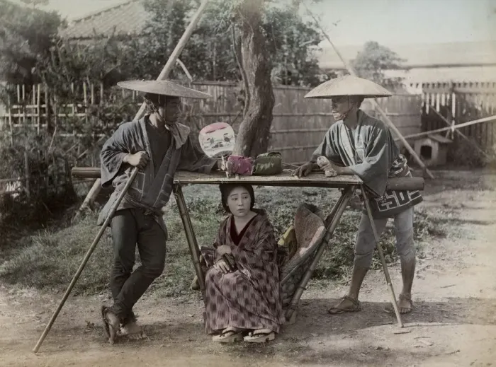 Framed Print : Young woman in carrying chair, kago, Japan, with porters Framed Print : Young woman in carrying chair, kago, Japan, with porters