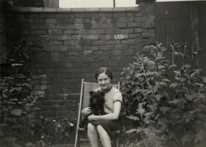 Framed Print : Young woman in deckchair with dog Framed Print : Young woman in deckchair with dog