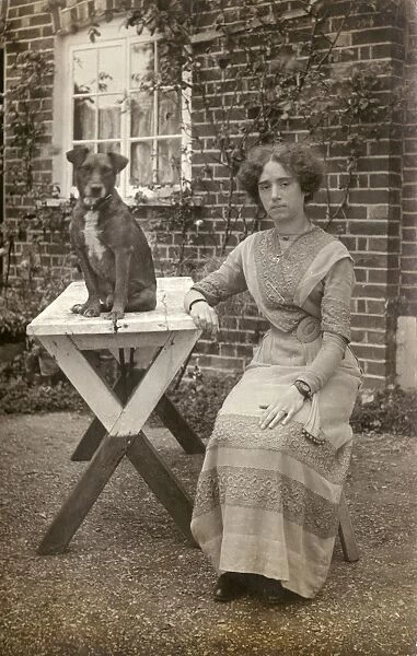 Young woman and dog in garden