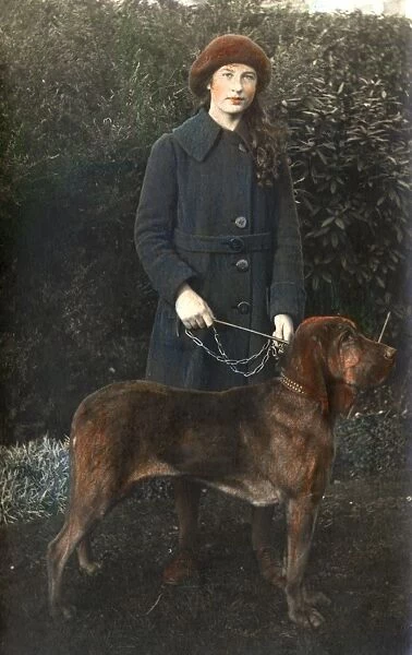 Young woman with a dog in a garden