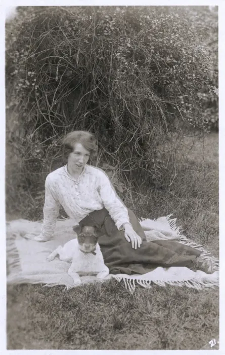 Framed Print : Young woman with a dog in a garden Framed Print : Young woman with a dog in a garden