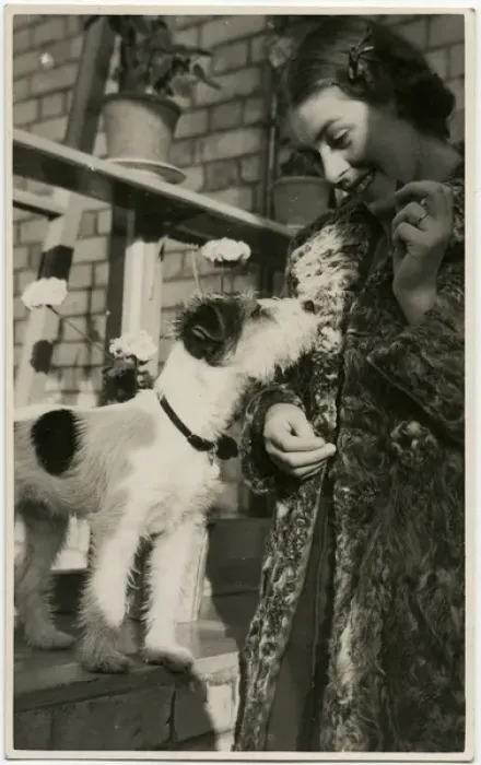 Framed Print : Young woman with a dog in a back garden Framed Print : Young woman with a dog in a back garden