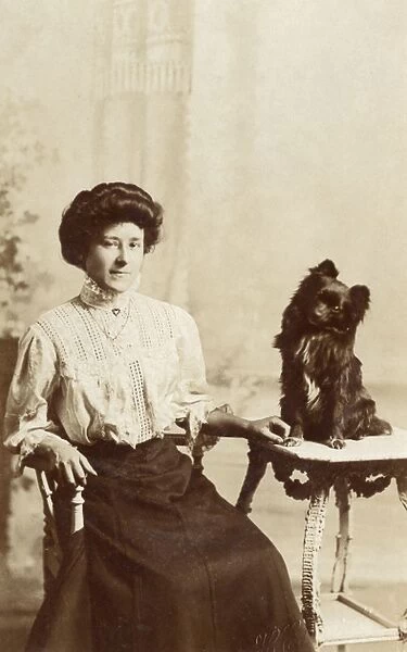 Young woman with dog in studio photo