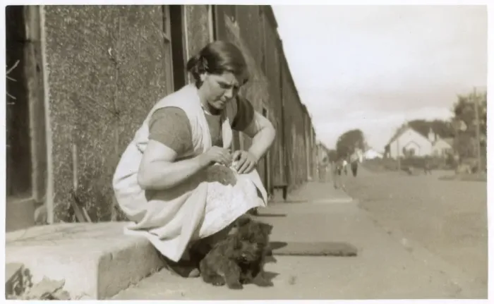 Framed Print : Young woman on doorstep with puppy Framed Print : Young woman on doorstep with puppy