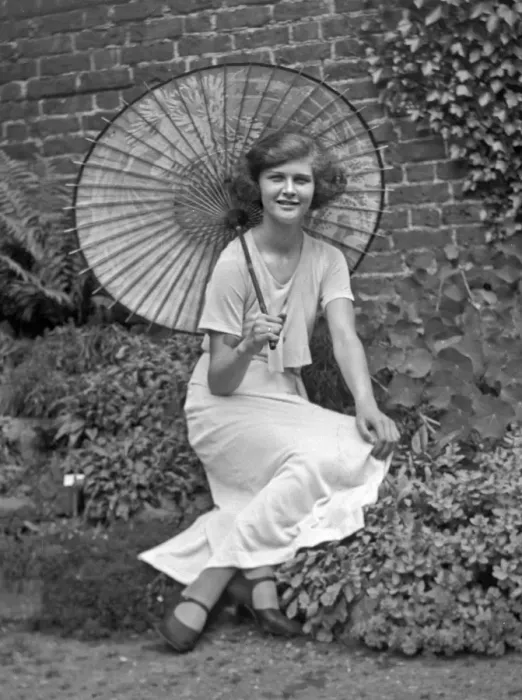 Framed Print : Young woman in a garden with a parasol