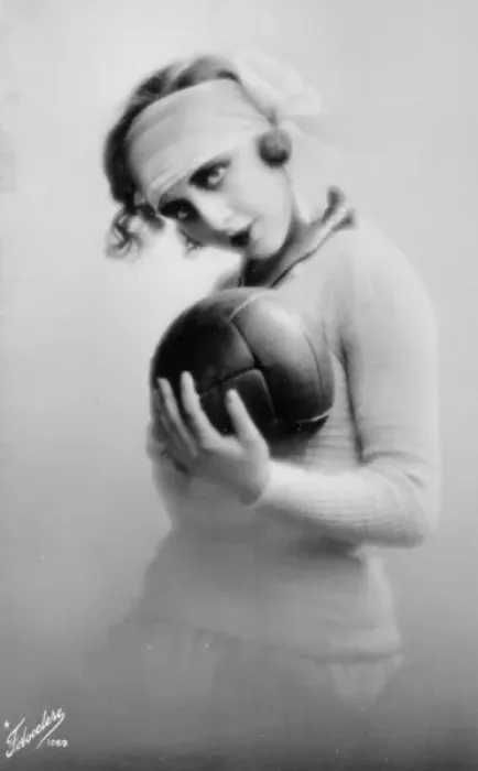 Framed Print : Young woman holding a football Framed Print : Young woman holding a football