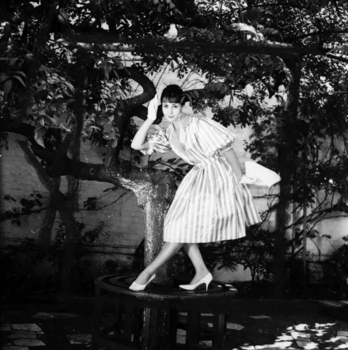 Framed Print : Young woman modelling a dress in a garden Framed Print : Young woman modelling a dress in a garden