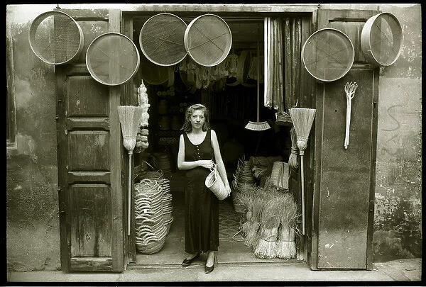 Young woman outside hardware shop, Valencia, Spain