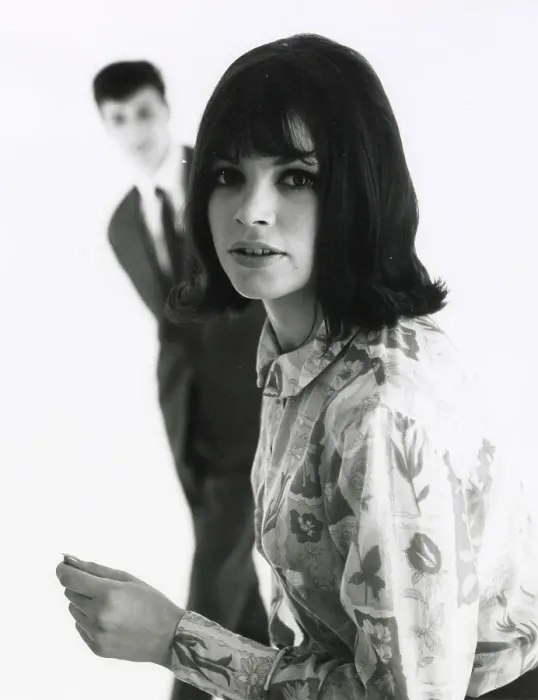 Framed Print : A young woman poses in the foreground with an out of focus male standing behind. Date: mid 1960s Framed Print : A young woman poses in the foreground with an out of focus male standing behind. Date: mid 1960s