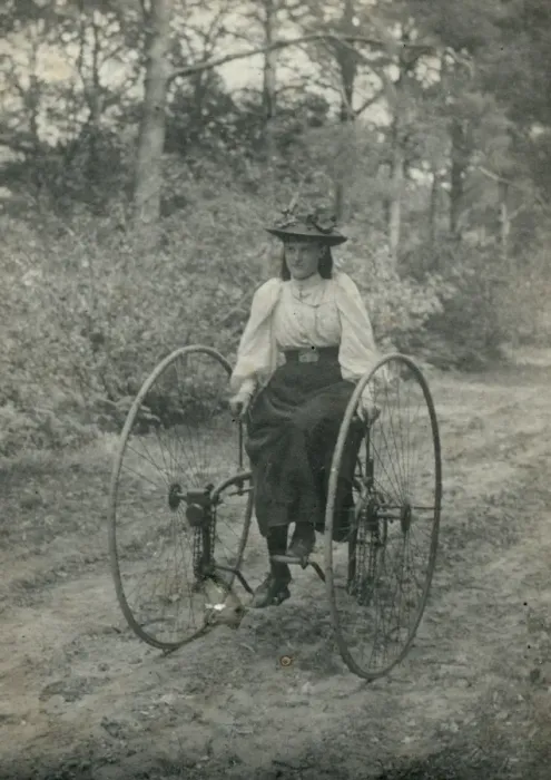 Framed Print : Young woman riding an early form of bicycle Framed Print : Young woman riding an early form of bicycle