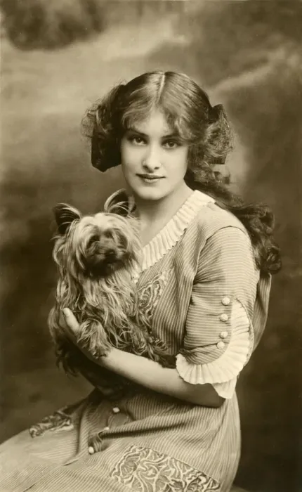 Framed Print : Young woman with small dog in studio portrait Framed Print : Young woman with small dog in studio portrait