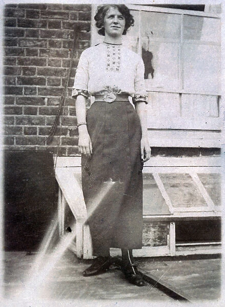 Young woman standing outside her home