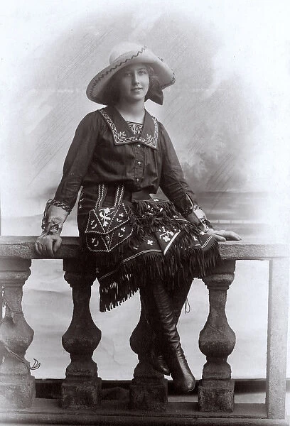 Young woman in a studio photo, wearing fancy dress