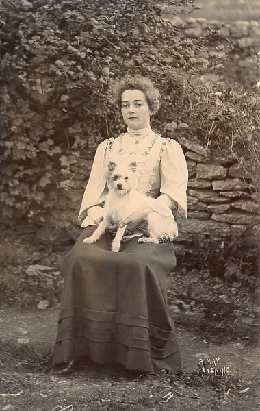 Young woman with a terrier in a garden