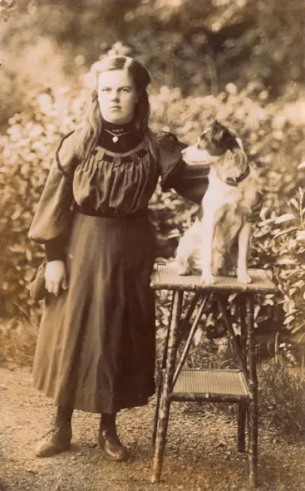 Framed Print : Young woman with a terrier in a garden Framed Print : Young woman with a terrier in a garden