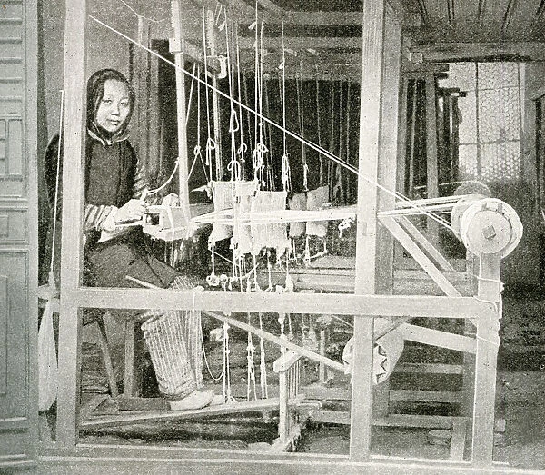 Young woman weaving on a loom, China, East Asia