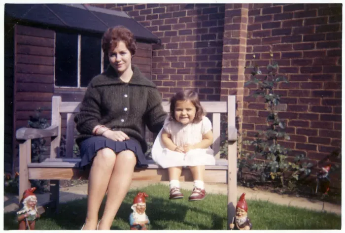 Framed Print : Young woman and her young niece on arden bench with gnomes Framed Print : Young woman and her young niece on arden bench with gnomes