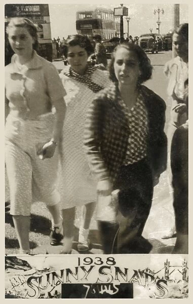 Four young women at the British seaside - walking past