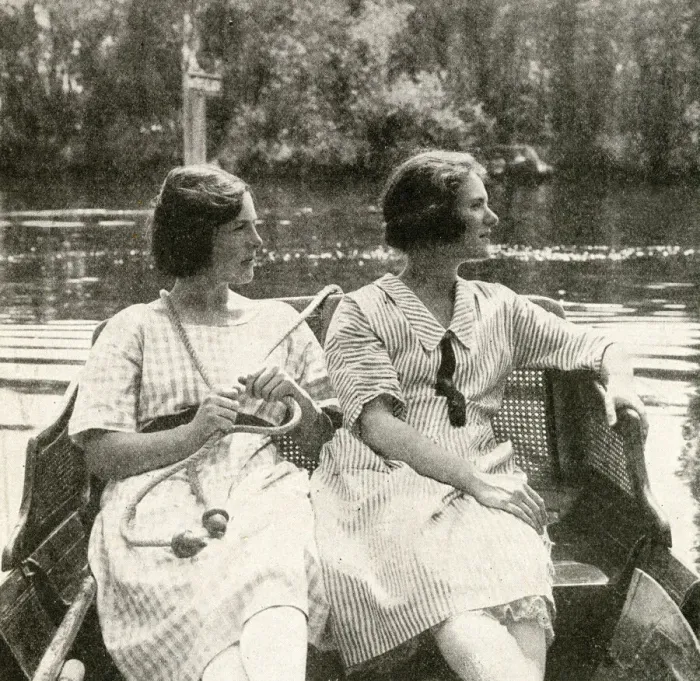 Framed Print : Two young women steering a barge on a river, England Framed Print : Two young women steering a barge on a river, England