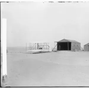 1903 machine and large camp building where it was housed, an