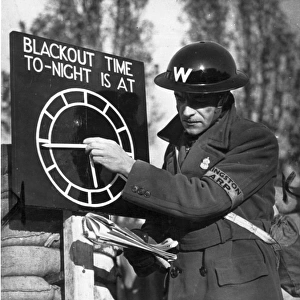 An Air Raid Warden adjusts the Blackout Time indicator