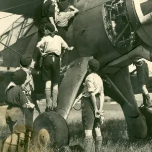 Air Scouts climbing on plane with Lord Olivier