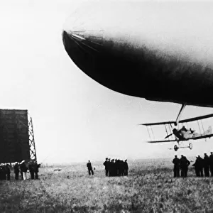 Airship with Biplane Fighter Aircraft Hanging Underneath