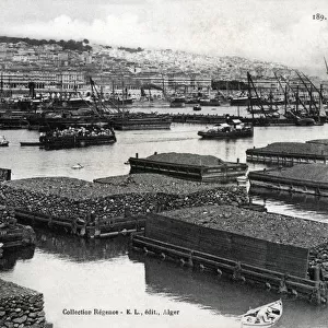 Algiers, Algeria - Quarried stone on floating barges in the harbour, awaiting export