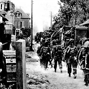Allied Troops moving through a French village; Second World