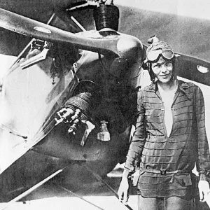 Amelia Earhart, pioneering aviator, with plane