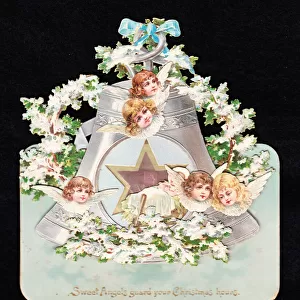 Angels and bell on a cutout Christmas card