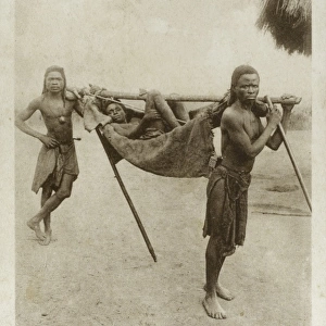 Angola - Njinga Tribesmen carry a sick patient