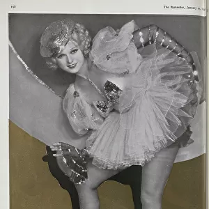 Anna Neagle, actress, theatrical portrait in sequined dance costume and tights, mono with sepia background. Captioned, The way of a Neagle'. With description, The latests of Anna Neagle
