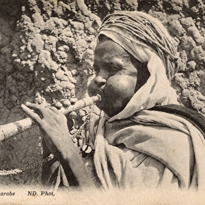 Arab Musician blowing a small horn - Algeria