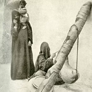 Arab woman with goatskin butter churn, near Cairo, Egypt