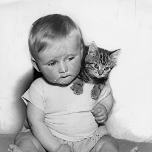 Baby with tabby kitten