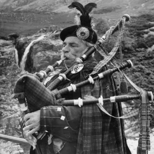 Bagpiper in Glen Coe, Highlands of Scotland