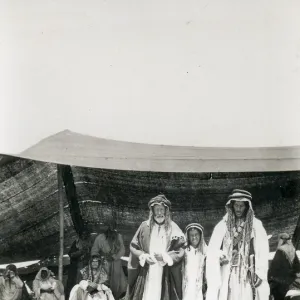 Two Bedouin men and a boy outside a tent, Middle East