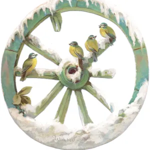 Blue tits perched on a wheel on a cutout Christmas card