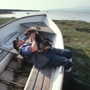Boatman and dog on the saltings at Askam, near Barrow Boatman and dog on the saltings at Askam, near Barrow
