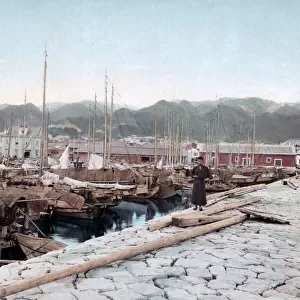 Boats tied up in Kobe harbour, Japan, circa 1890. Date: circa 1890