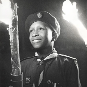 Boy of 3rd Bahamas Scout Troop in torchlight parade